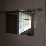 Aquavision Frameless waterproof Tv with black glass mounted in a bathroom