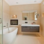Aquavision Frameless waterproof Tv with black glass mounted in a bathroom