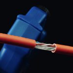 Simply45 Cable stripper head clamped over a cable after stripping. showing wires exposed.