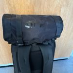 Dizzyfish TuknRoll Multi-purpose Tool Bag shown rolled up on top of a backpack.