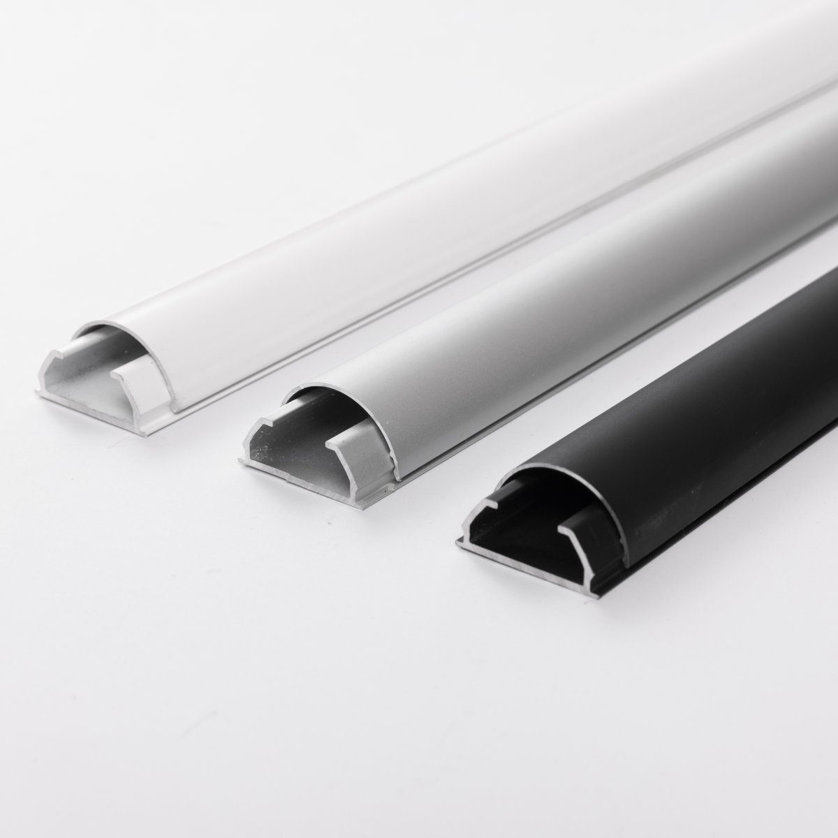 BOSSCOM Cable Covers 25mm showing three colours: black, aluminium and white shown from the side.