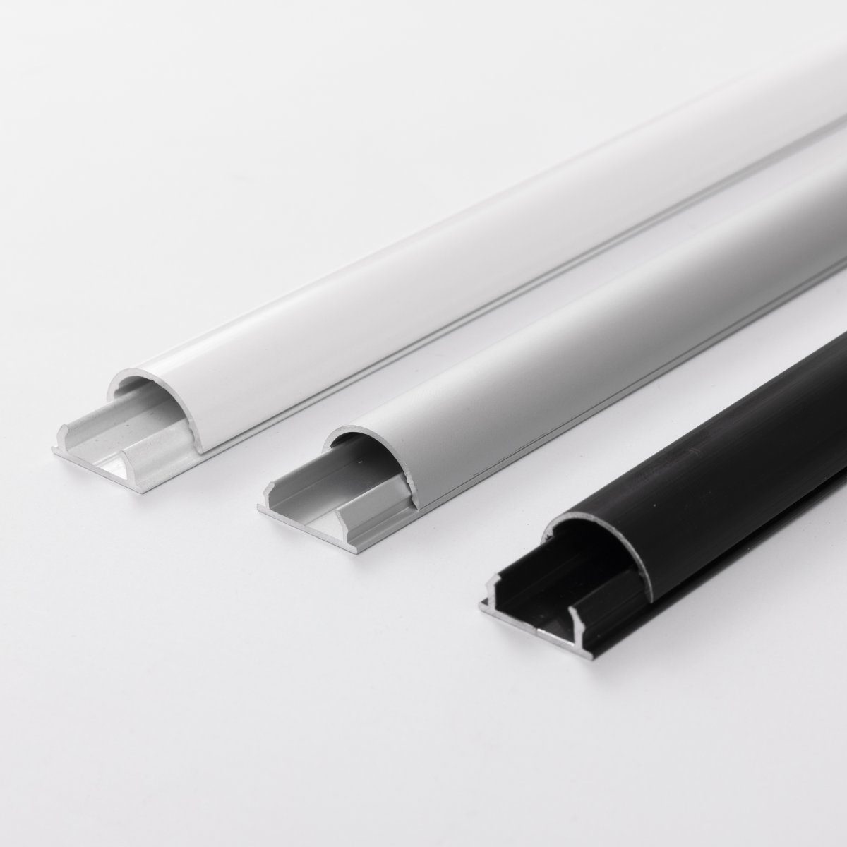 BOSSCOM Cable Covers 18mm showing three colours: black, aluminium and white shown from the side.