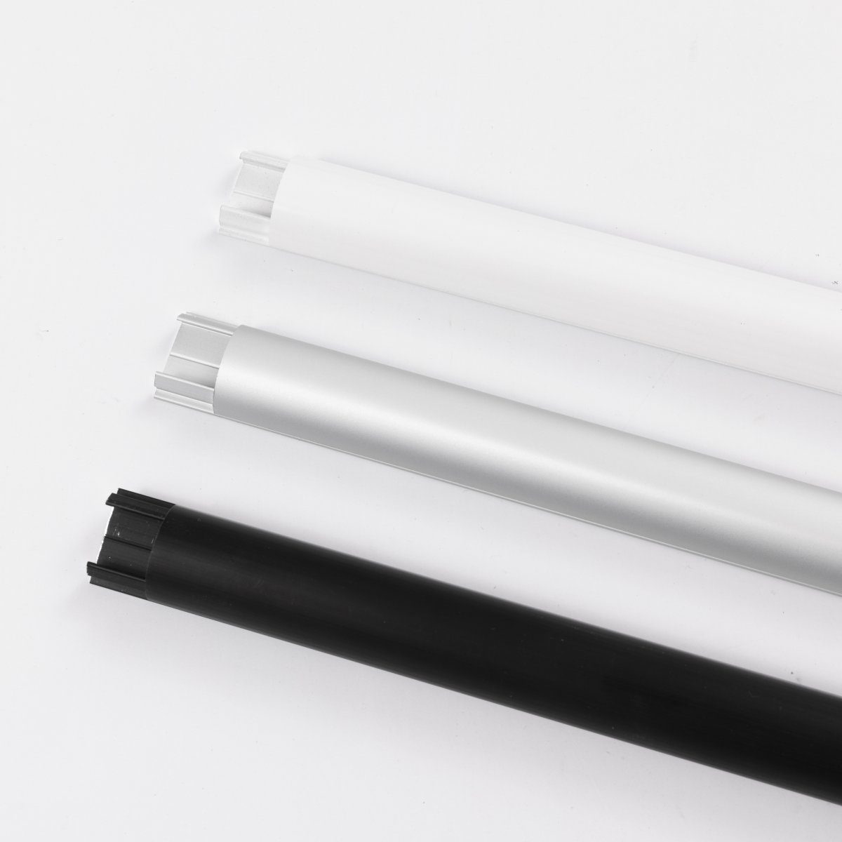 BOSSCOM Cable Covers 18mm showing three colours: black, aluminium and white shown from above.