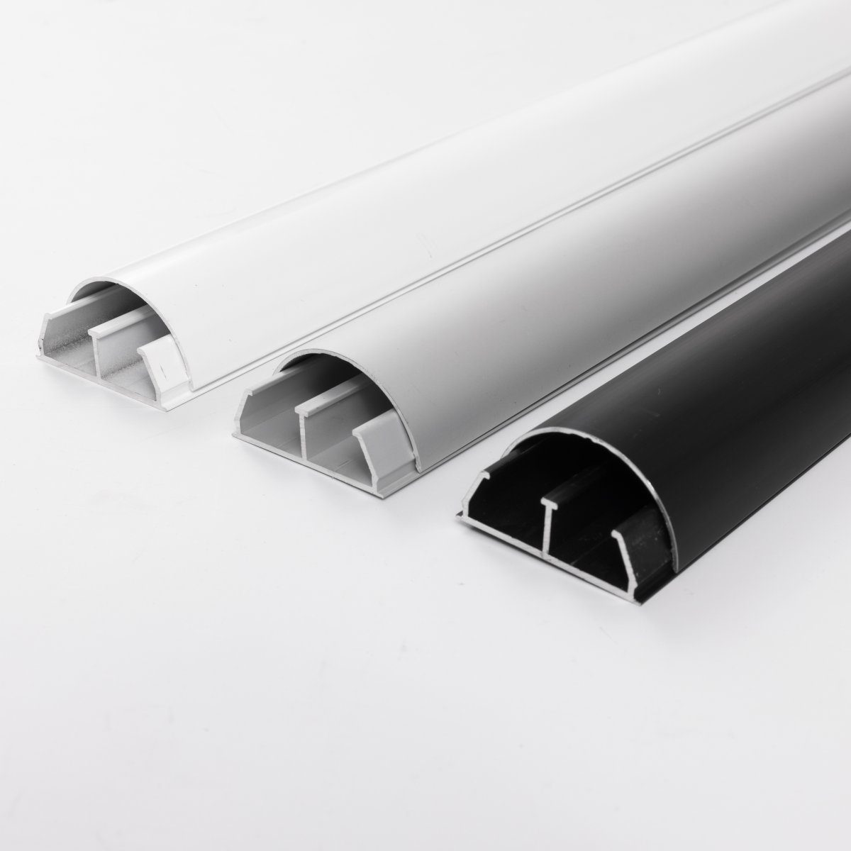 BOSSCOM Cable Covers 50mm showing three colours: black, aluminium and white shown from the side.
