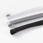 BOSSCOM Cable Sock with Zip showing three colours available: Black, Grey and White and the zip fastening at the top.