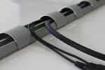 BOSSCOM Click n' Slide cable tidy showing cable tidy with cables within.