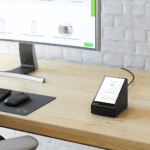 FSR DSKB-TSW-570-PT desktop touchscreen mounting shown on a desk with a Crestron screen in place in the mount.
